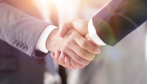 two people in suits shaking hands