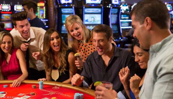 group of adults cheering playing table games