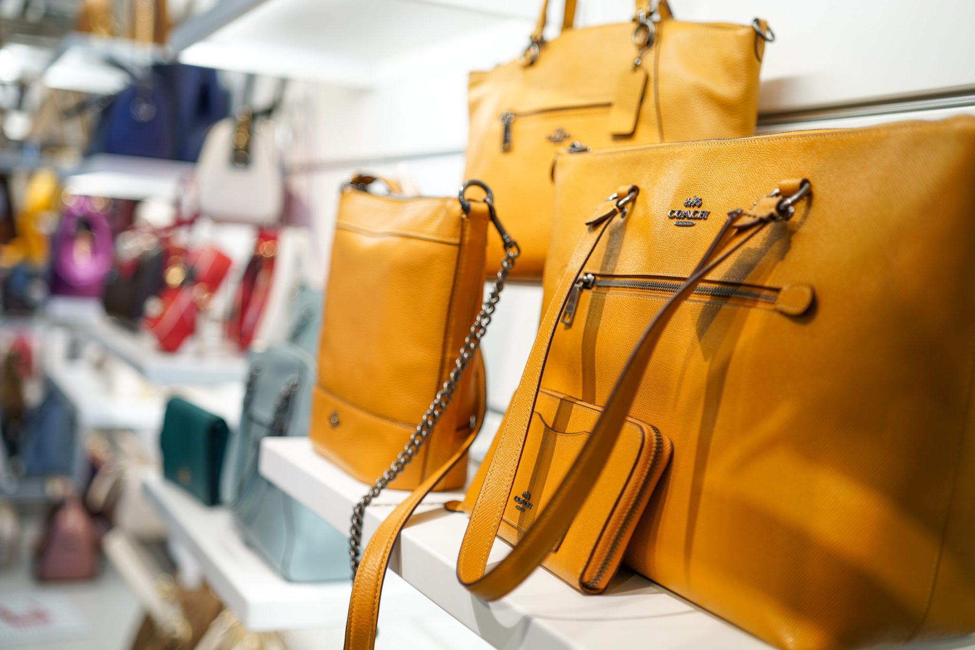 display of mustard color coach purses